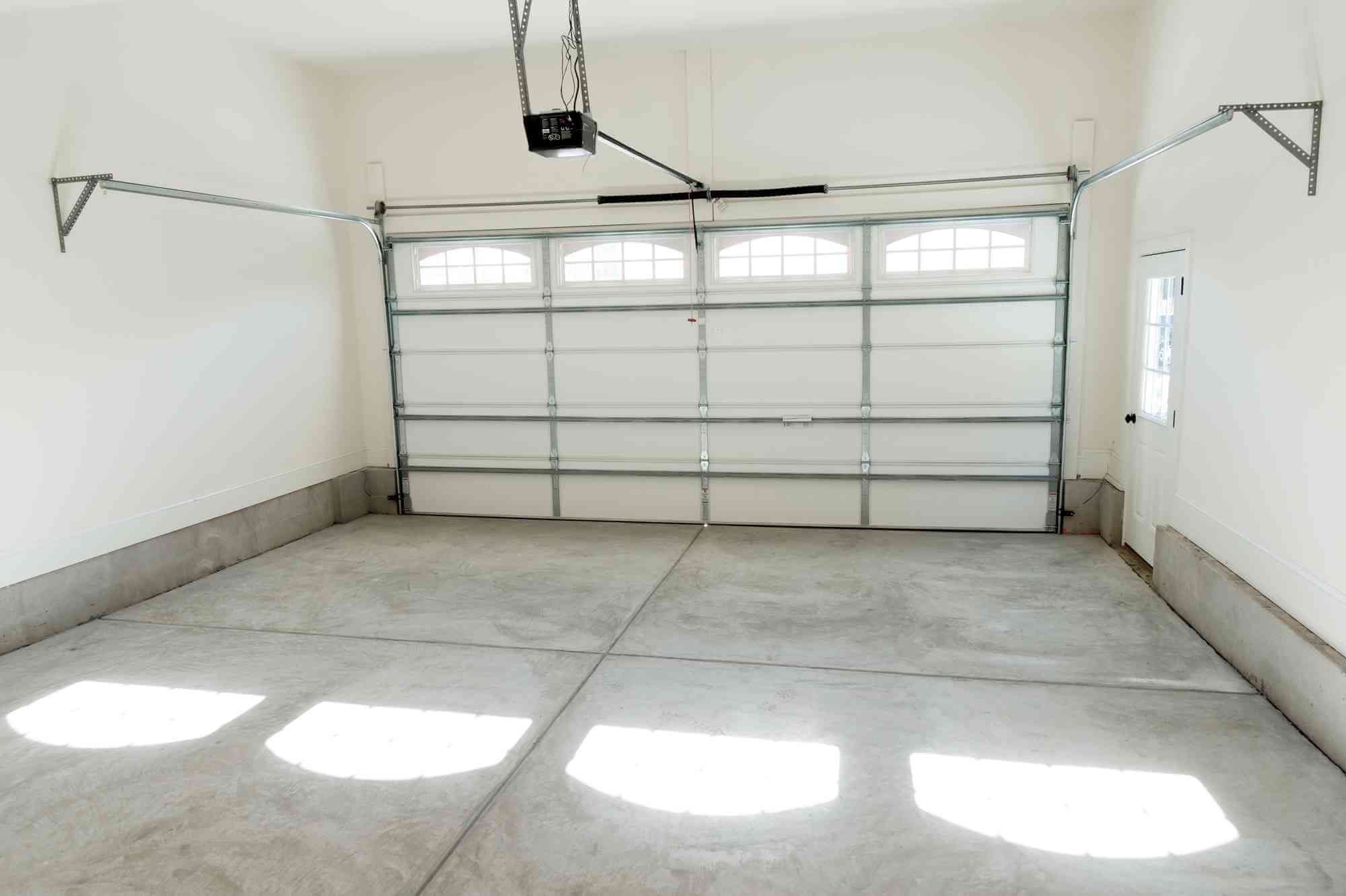 white modern minimalist garage interior with up and over garage door